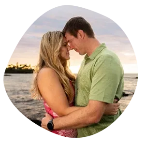 Couple sharing romantic moment on Hawaii beach during golden sunset hour