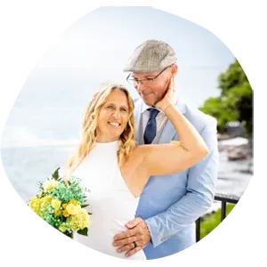 Bride and groom embracing with white and green tropical bouquet in Hawaii