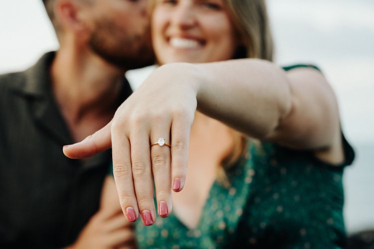 A woman showing her engagement ring