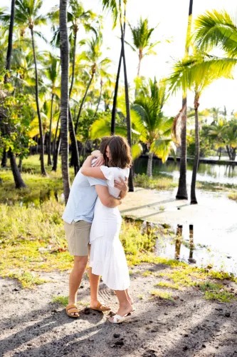 Bride walking down palm tree-lined tropical path for destination wedding in Hawaii