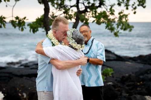 Couple embracing during a Hawaiian wedding