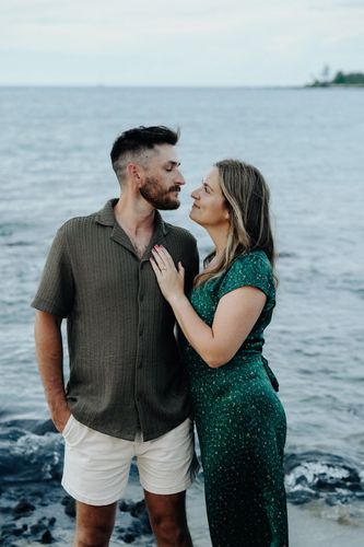A man and woman embracing on the beach in Hawaii