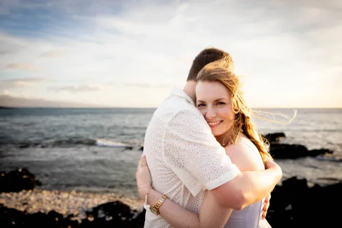 Bride and groom with black volcanic lava rocks in Hawaii